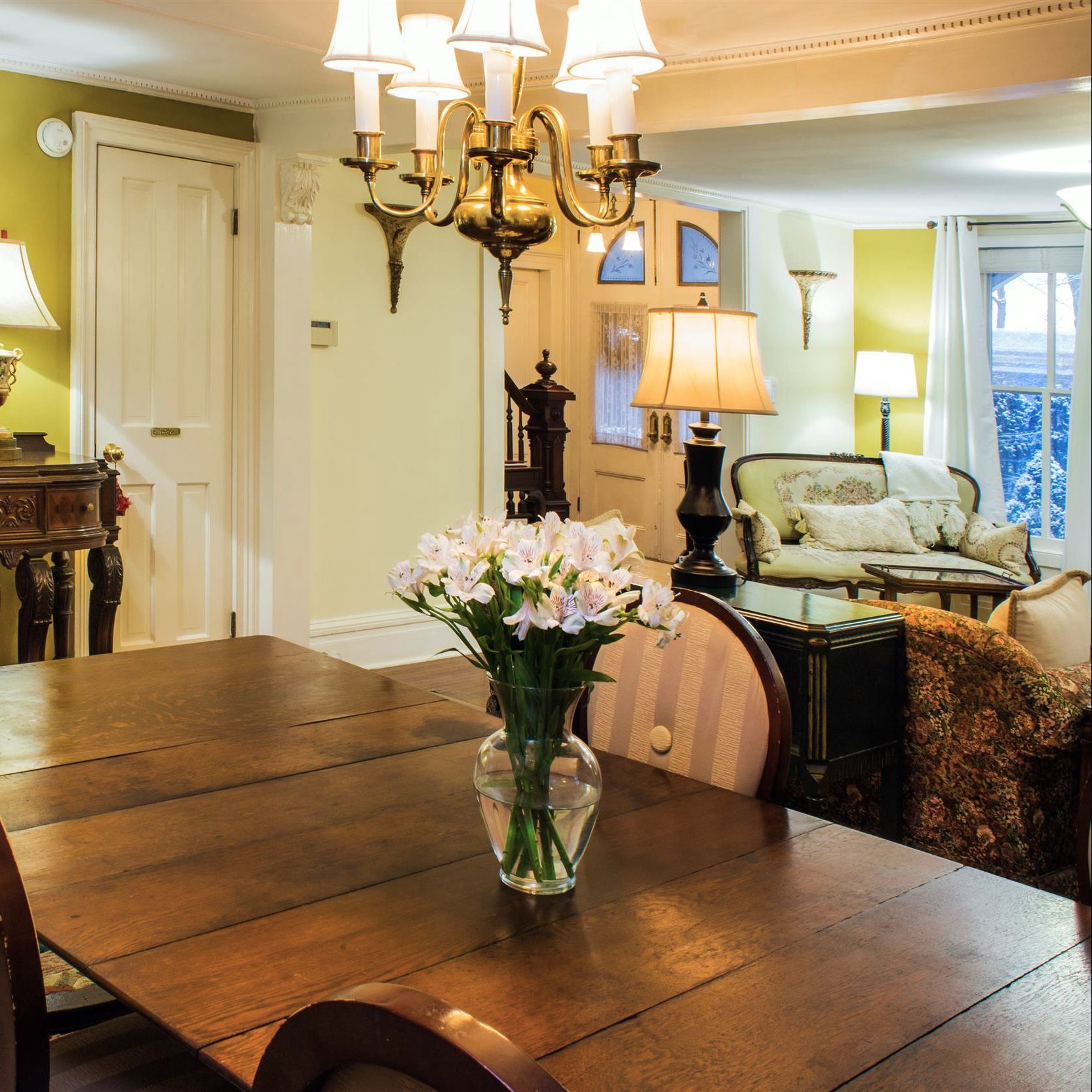 A vase of flowers sits on a table in a living room