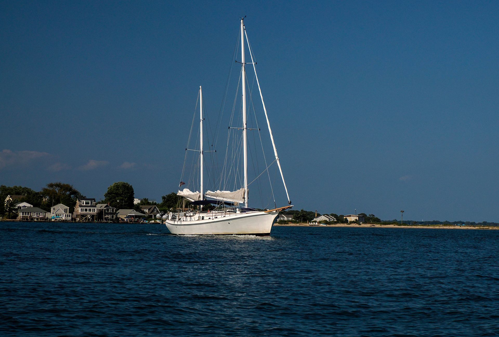 A sailboat is floating on top of a body of water.
