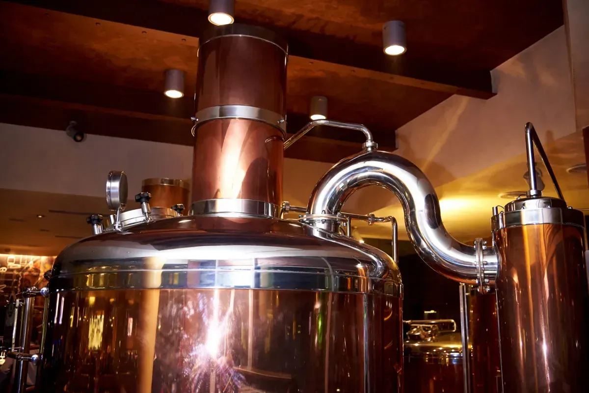 A large copper tank with a pipe coming out of it