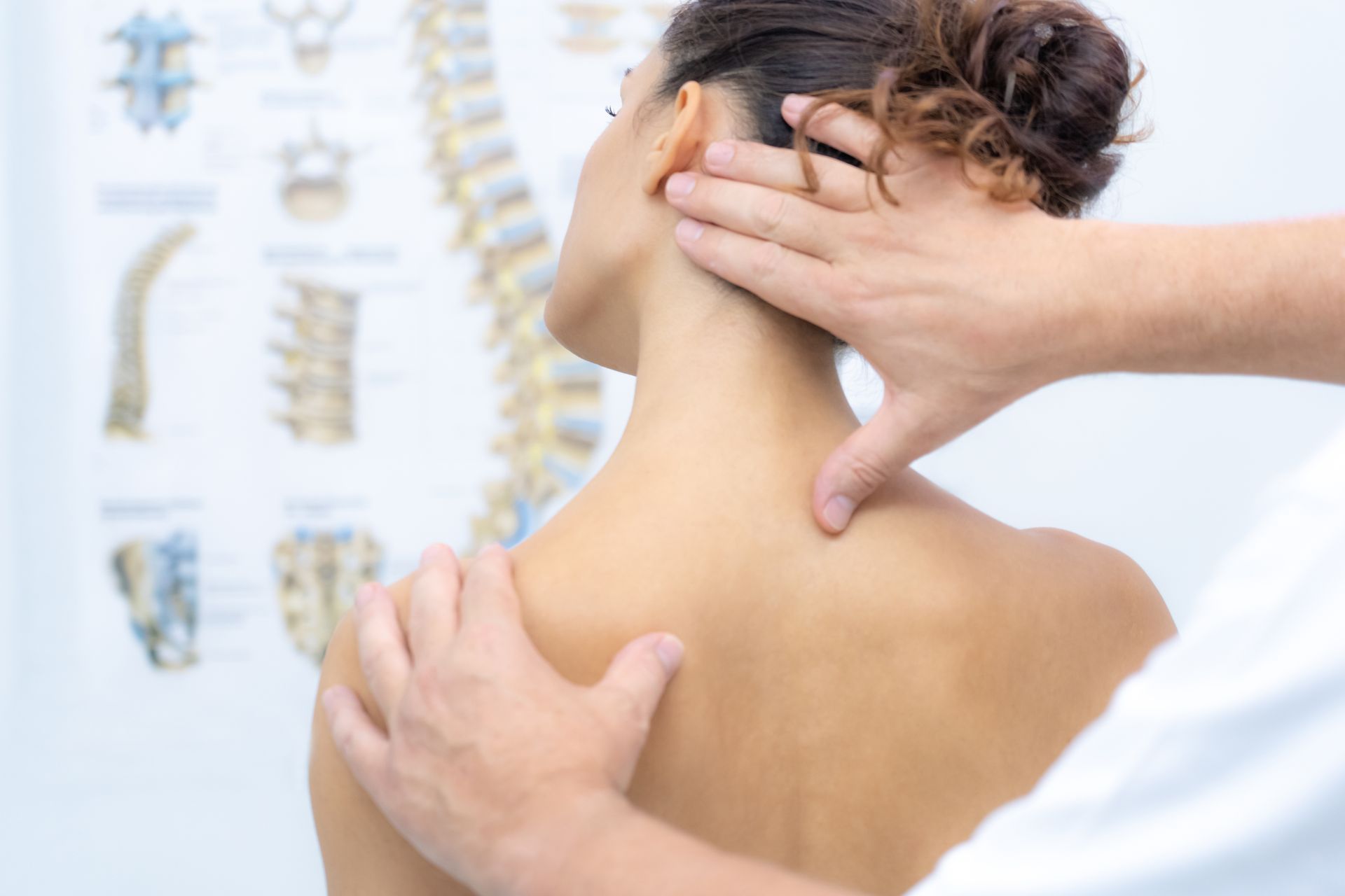 A person receiving a neck and shoulder massage from a healthcare professional in a clinic.