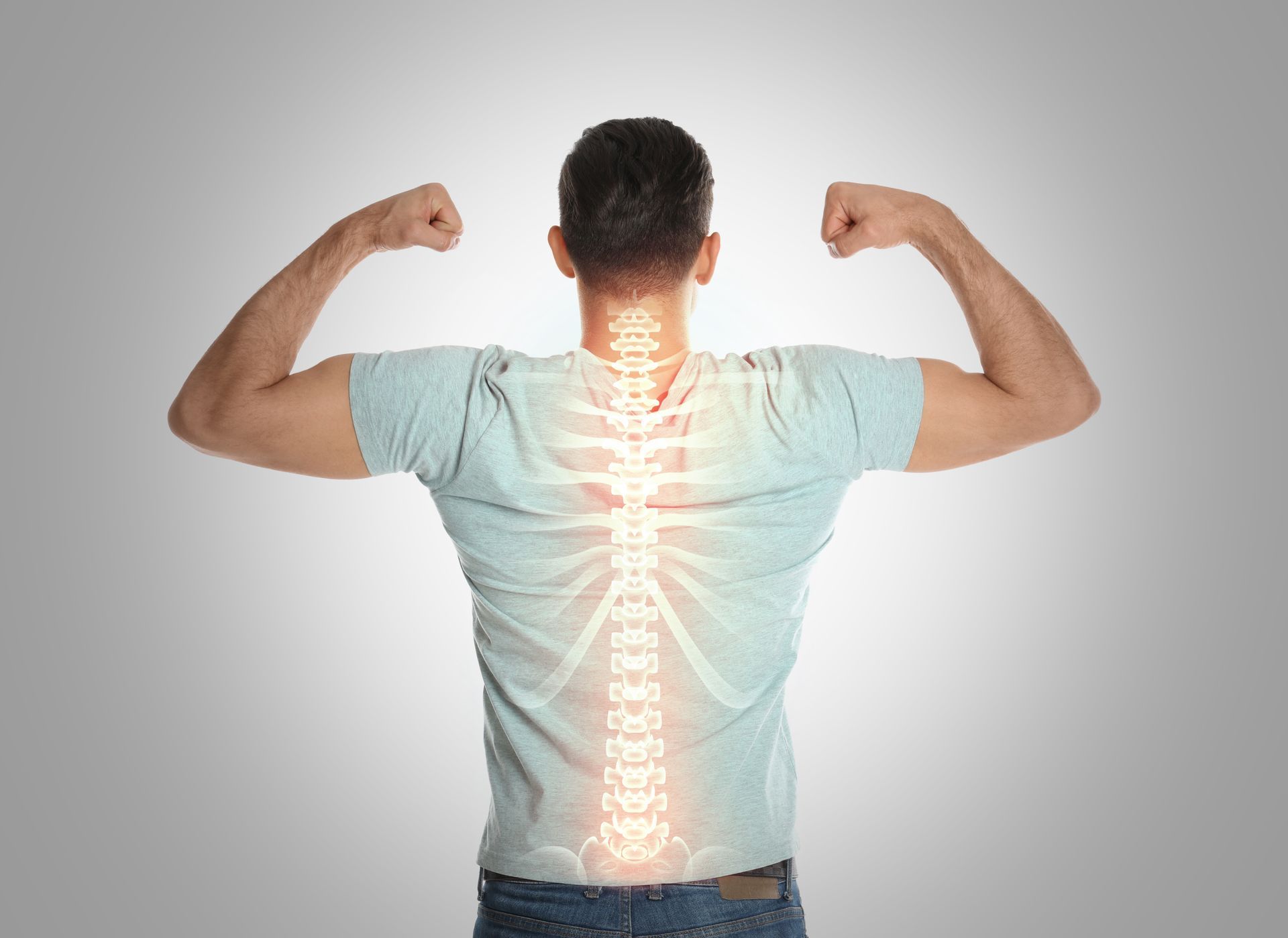 Man flexing with spine illustration overlaid on his back.