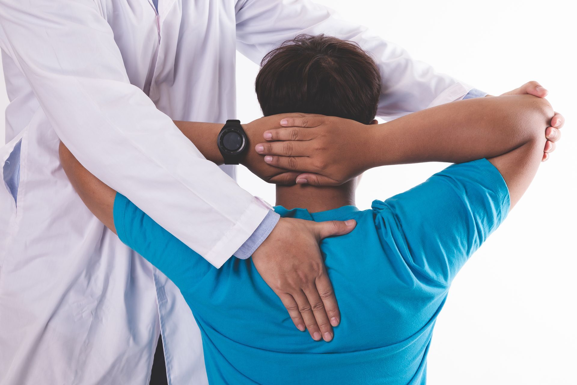 Doctor adjusting a patient's neck and back; white lab coat, blue shirt.