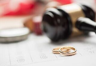 Wedding ring, gavel in background — Criminal Law in Fremont, NE