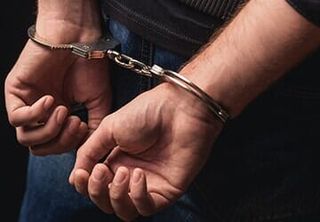 Man in handcuffs — Criminal Law in Fremont, NE