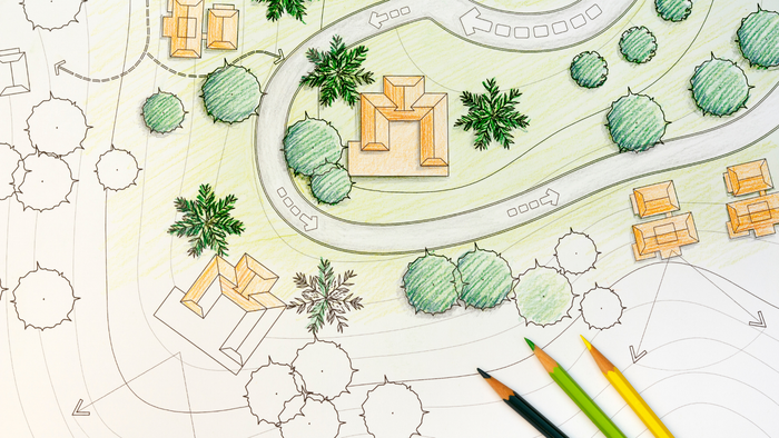 Een plattegrondtekening van een tuin met pad, struiken en bomen.