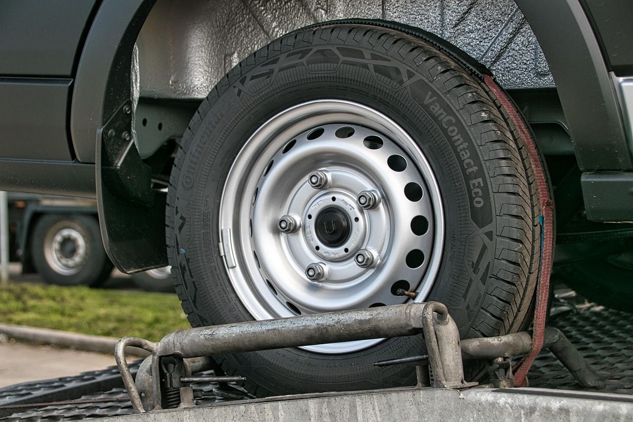 A close up of a car wheel on a trailer.
