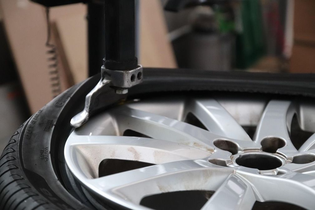A close up of a tire being changed on a machine