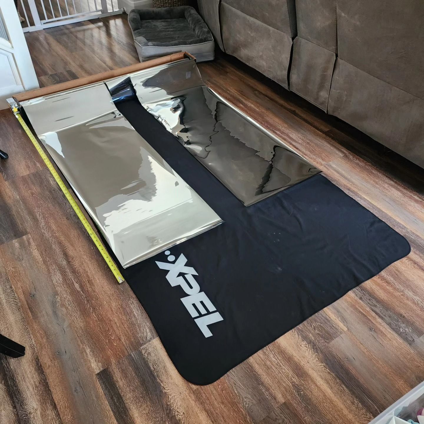 A xpel mat is on the floor next to a mirror