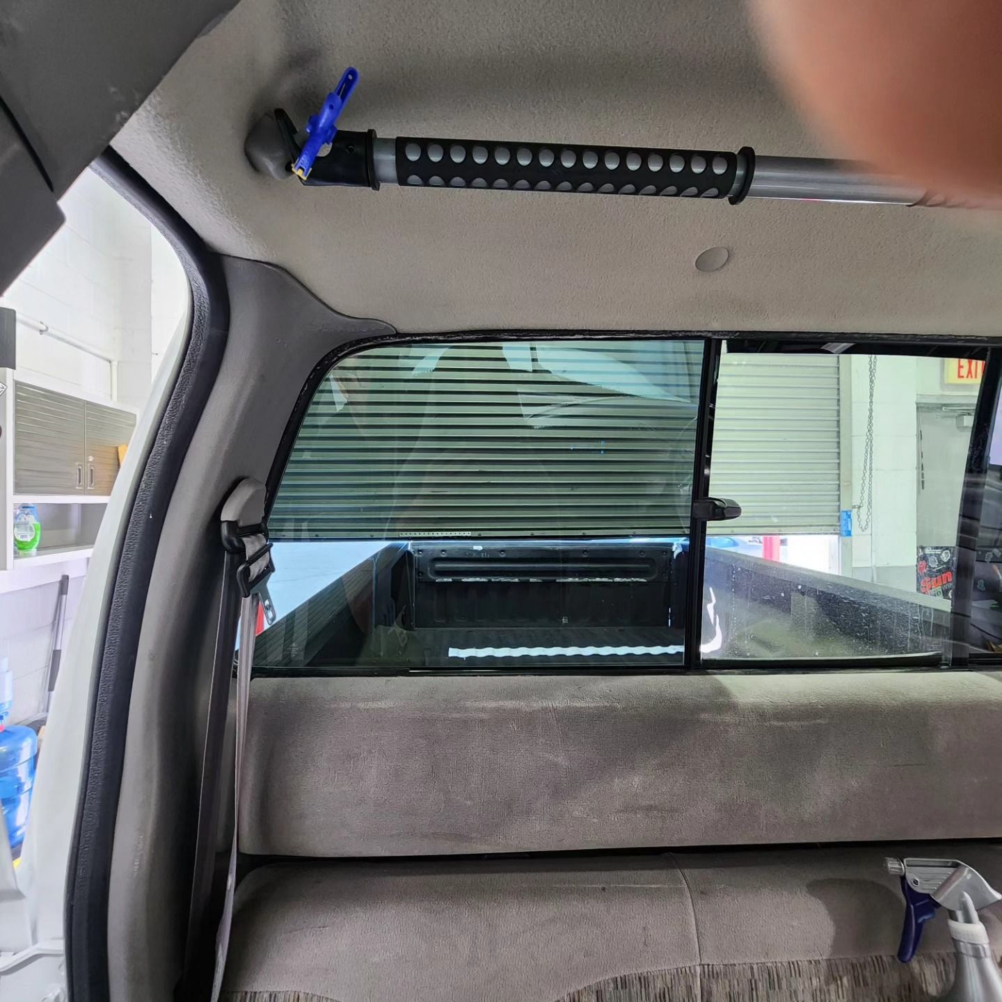 A person is standing in the back seat of a truck.