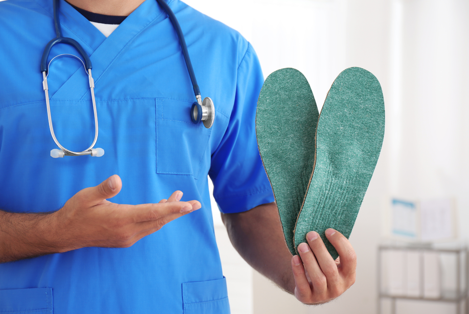 A person wearing blue gloves is holding another person 's foot