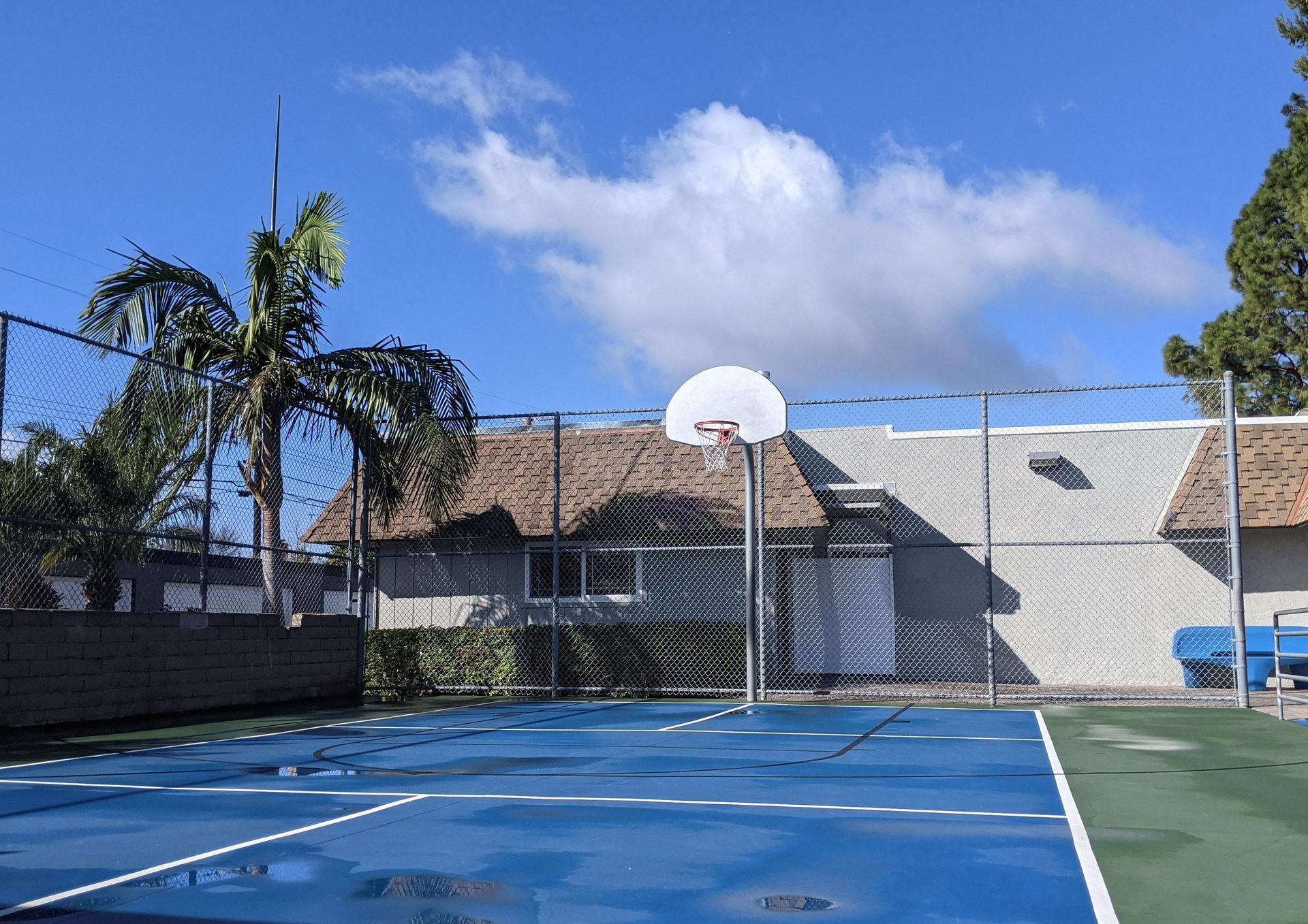 Basketball hoop on blue sports court ground
