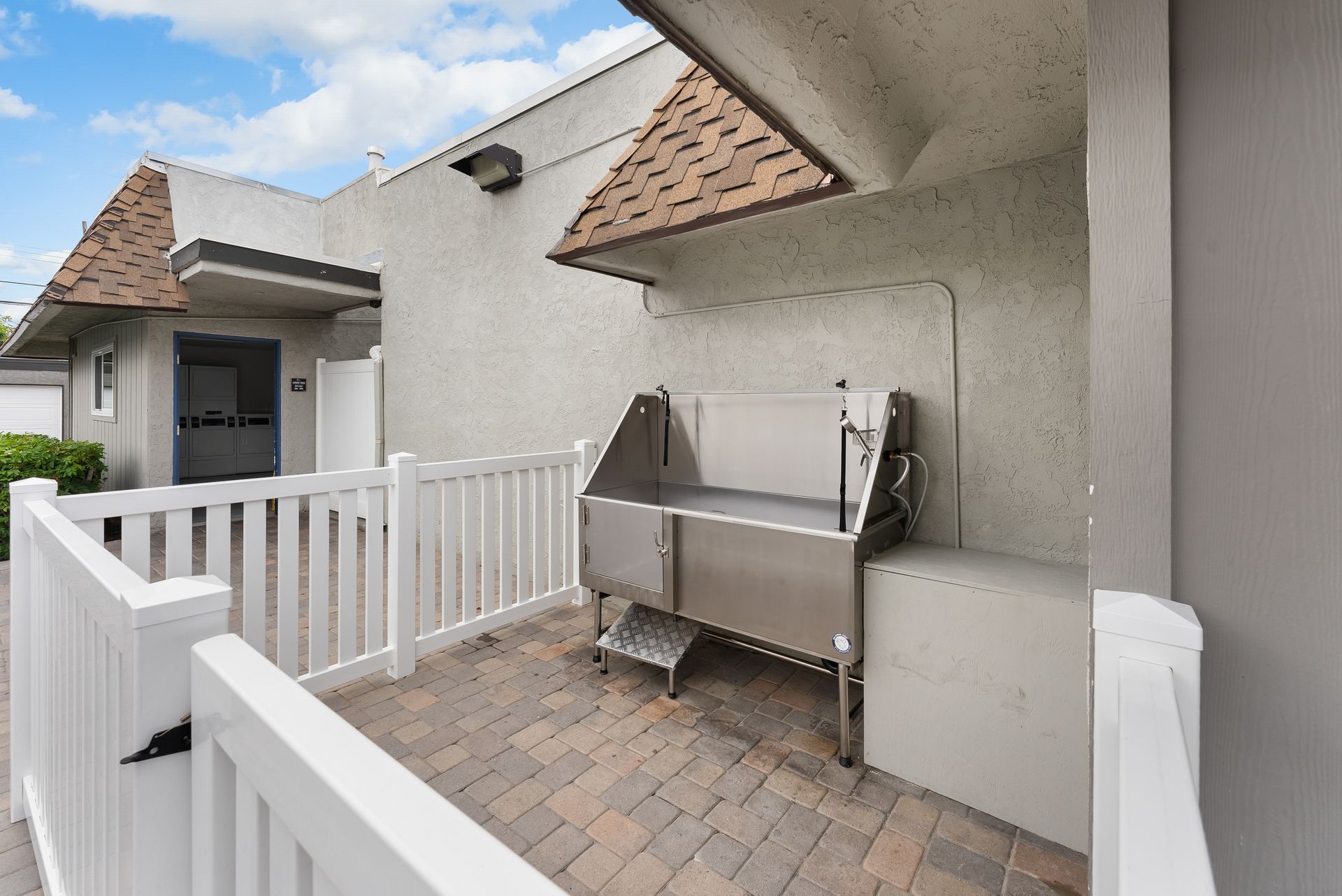 Dog was station surrounded by white fence