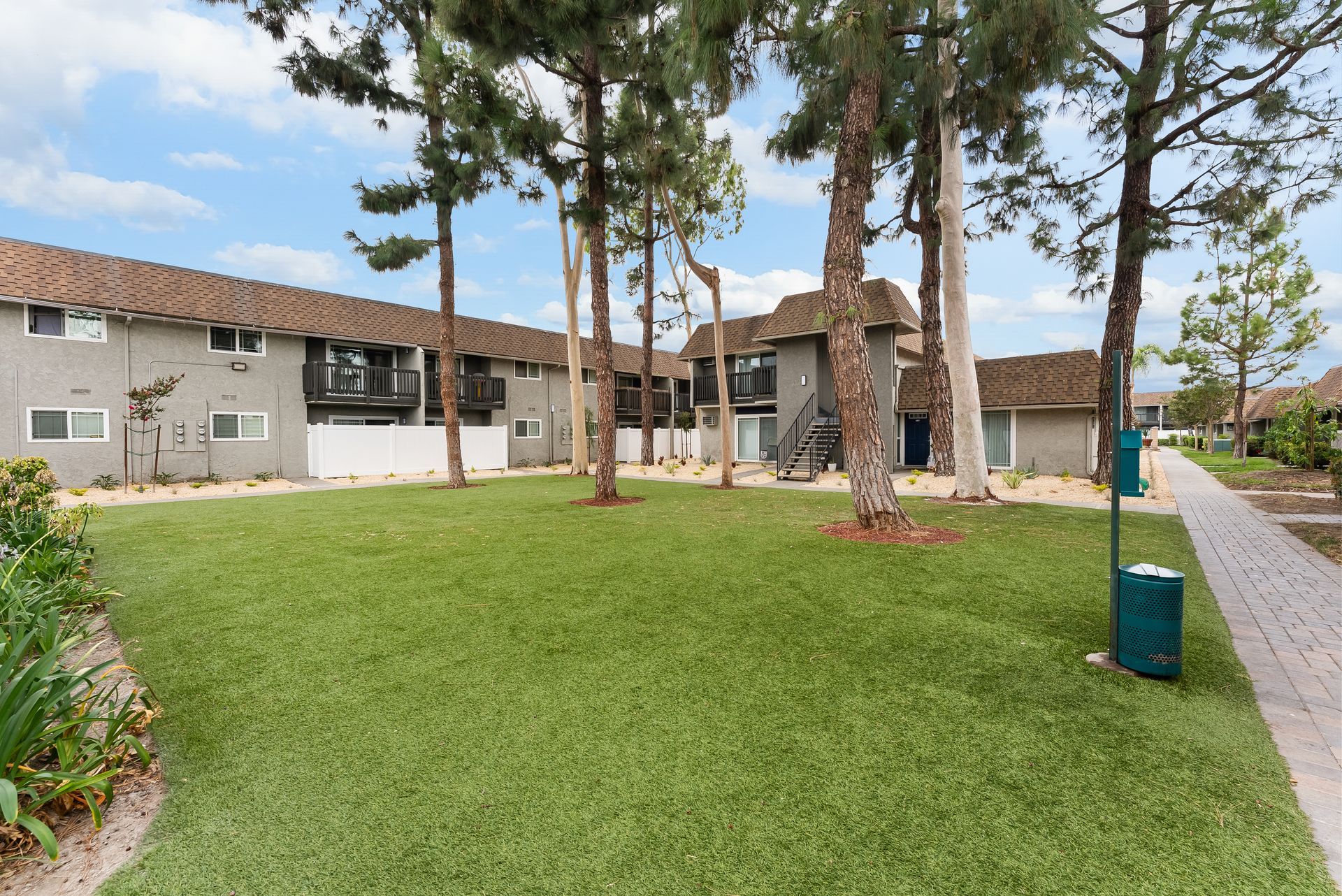 Large grass courtyard with trees