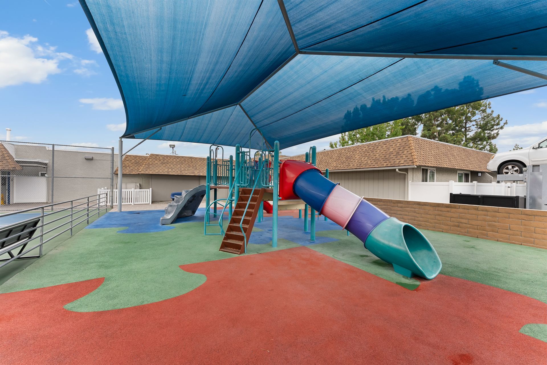 Rainbow colored playground with slide