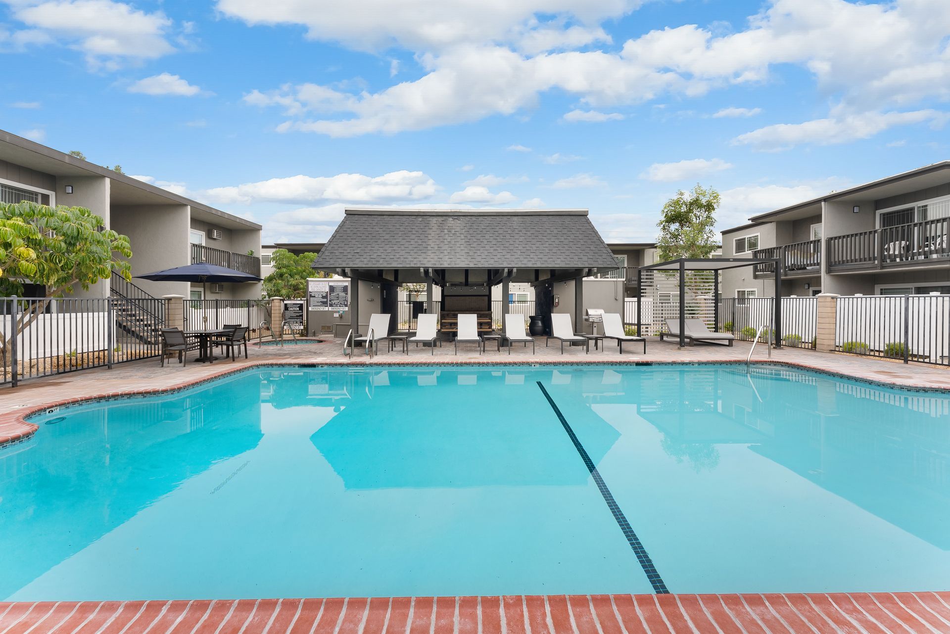 Swimming pool with gazebo and chairs