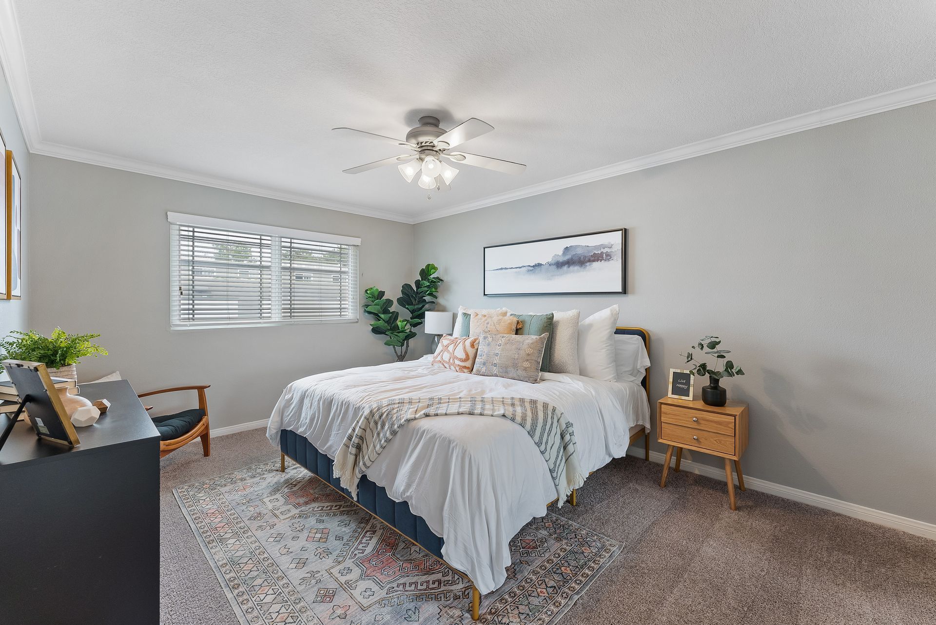 Master bedroom with queen sized bed with white bedspread