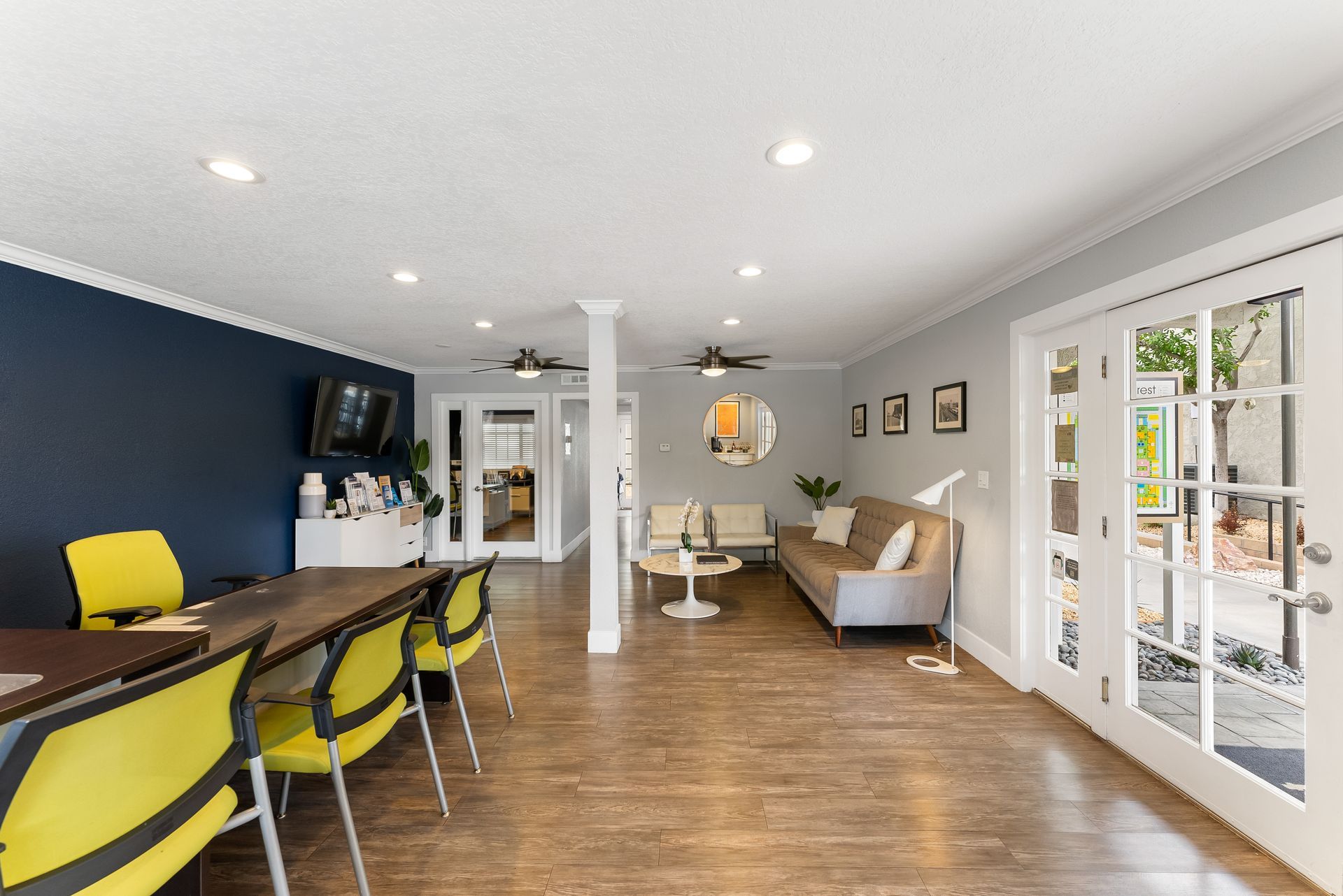Community office with cough, yellow chairs, and desk