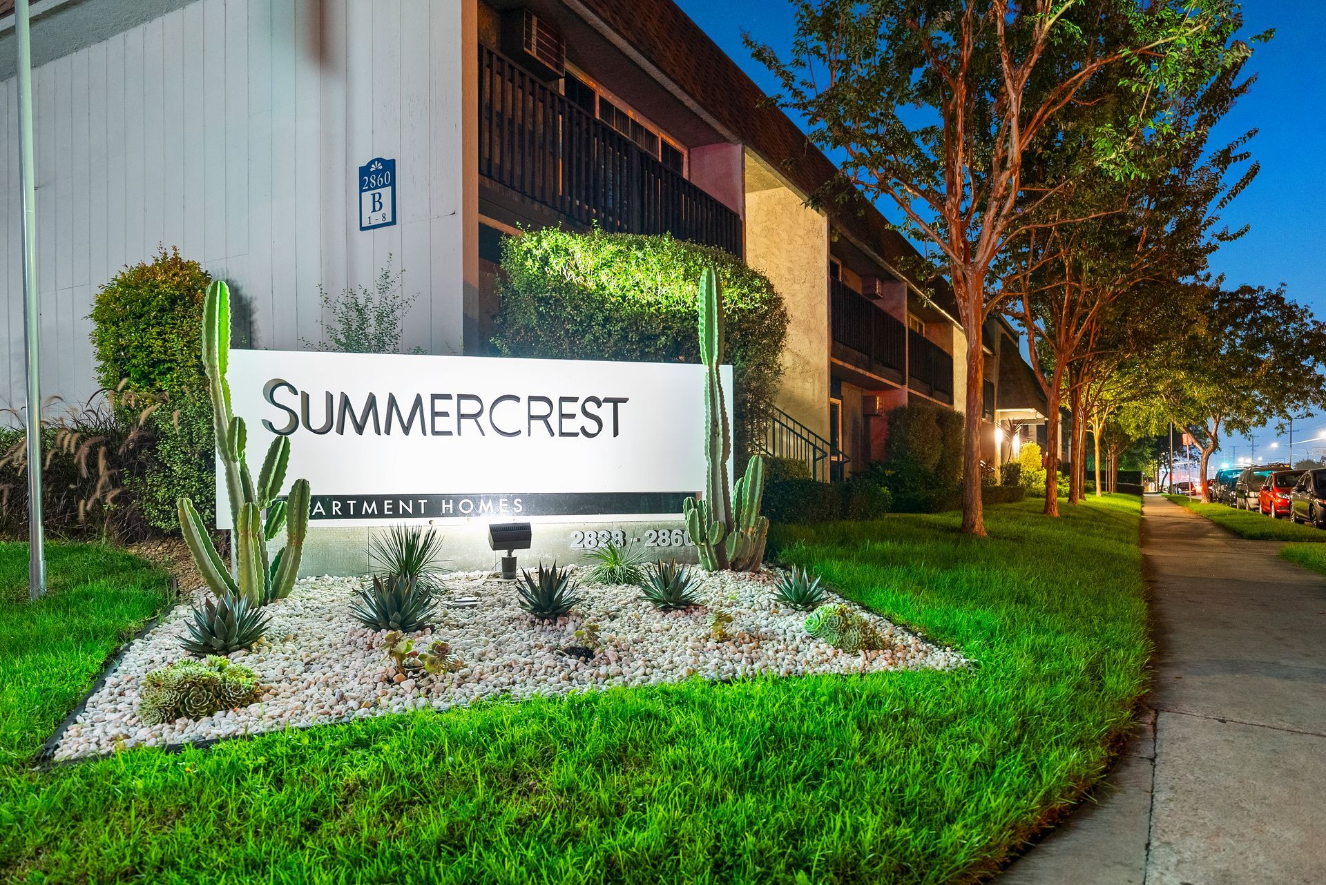 Exterior streetside building with Summer Crest sign at twilight