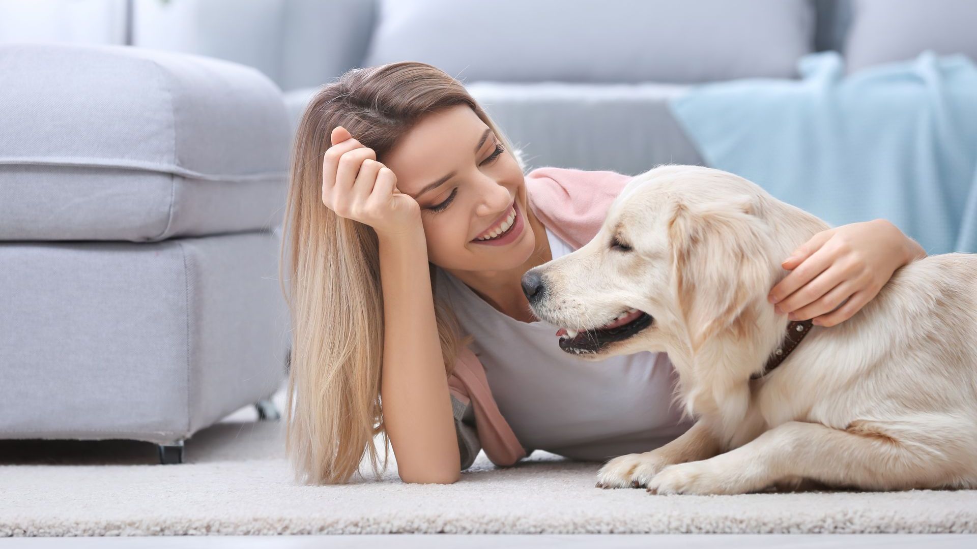 woman smiling at her dog 