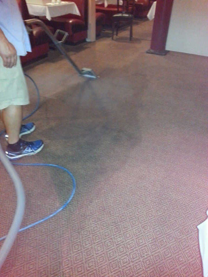 A person is cleaning a wall with a spray bottle.