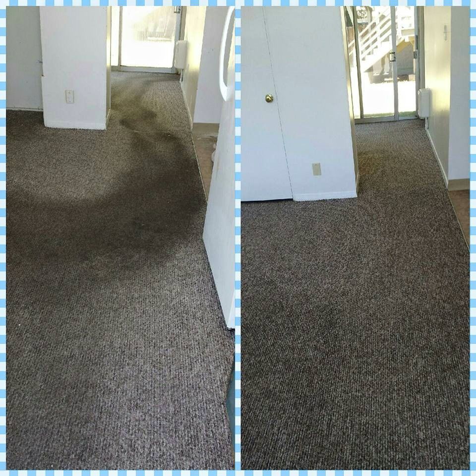 A person is cleaning an office chair with a vacuum cleaner