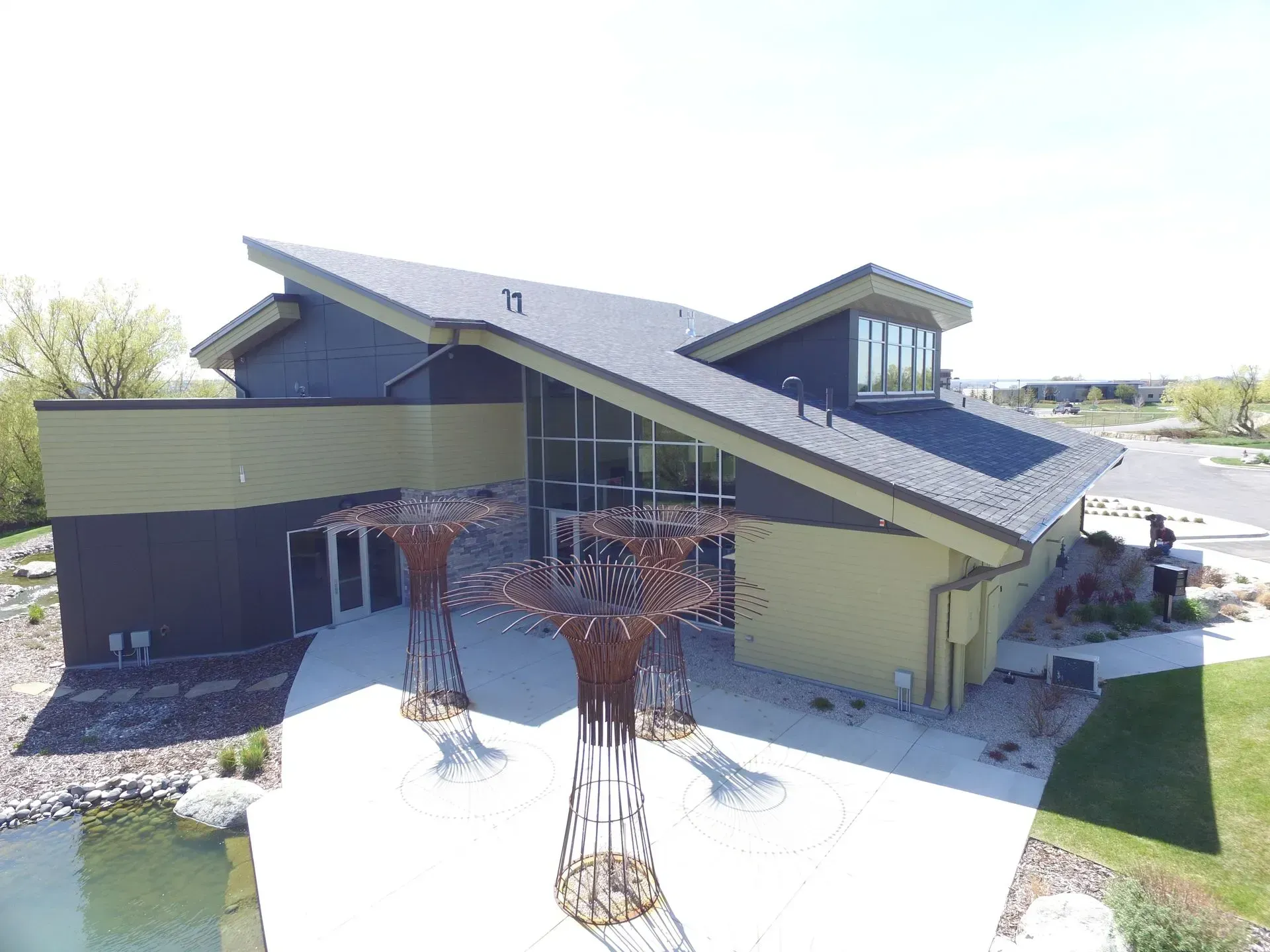 An aerial view of a large building with a tree in front of it.