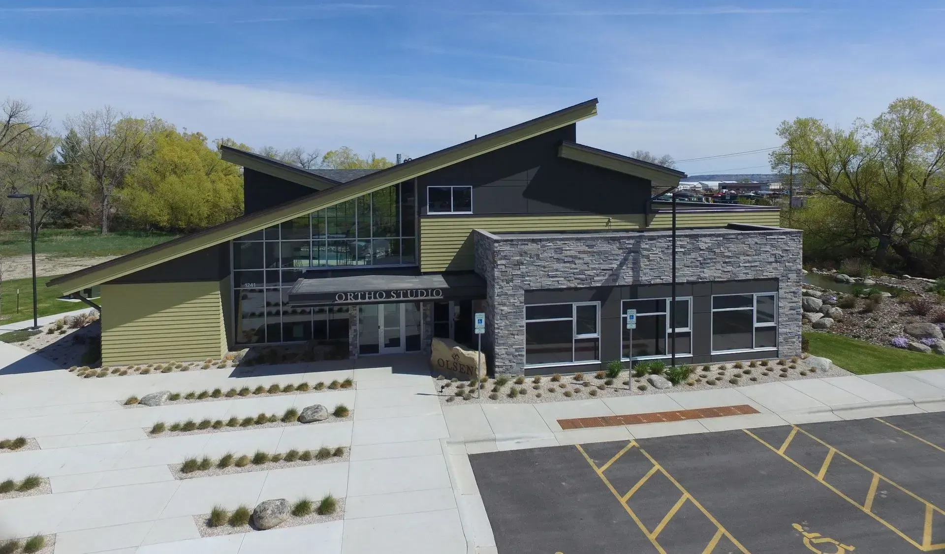 An aerial view of a large building with a parking lot in front of it.