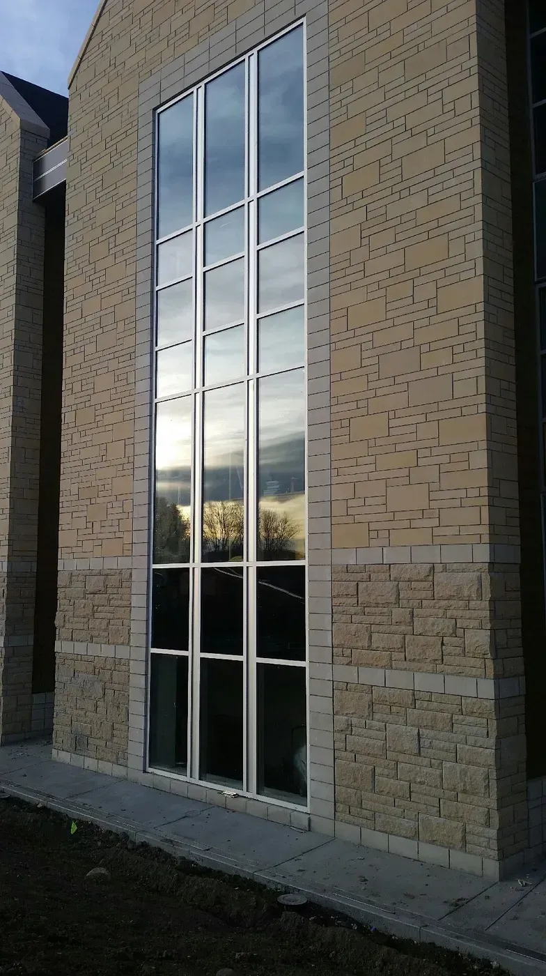 A large window on the side of a brick building