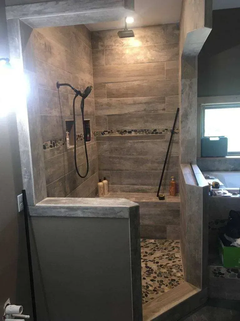 A bathroom with a walk in shower and a bathtub.