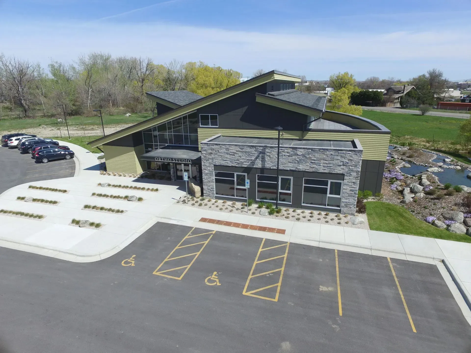 An aerial view of a building with a parking lot in front of it.
