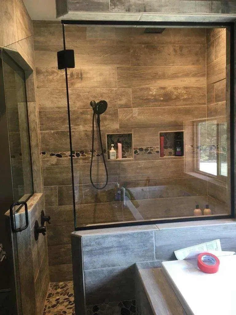 A bathroom with a walk in shower and a bathtub.
