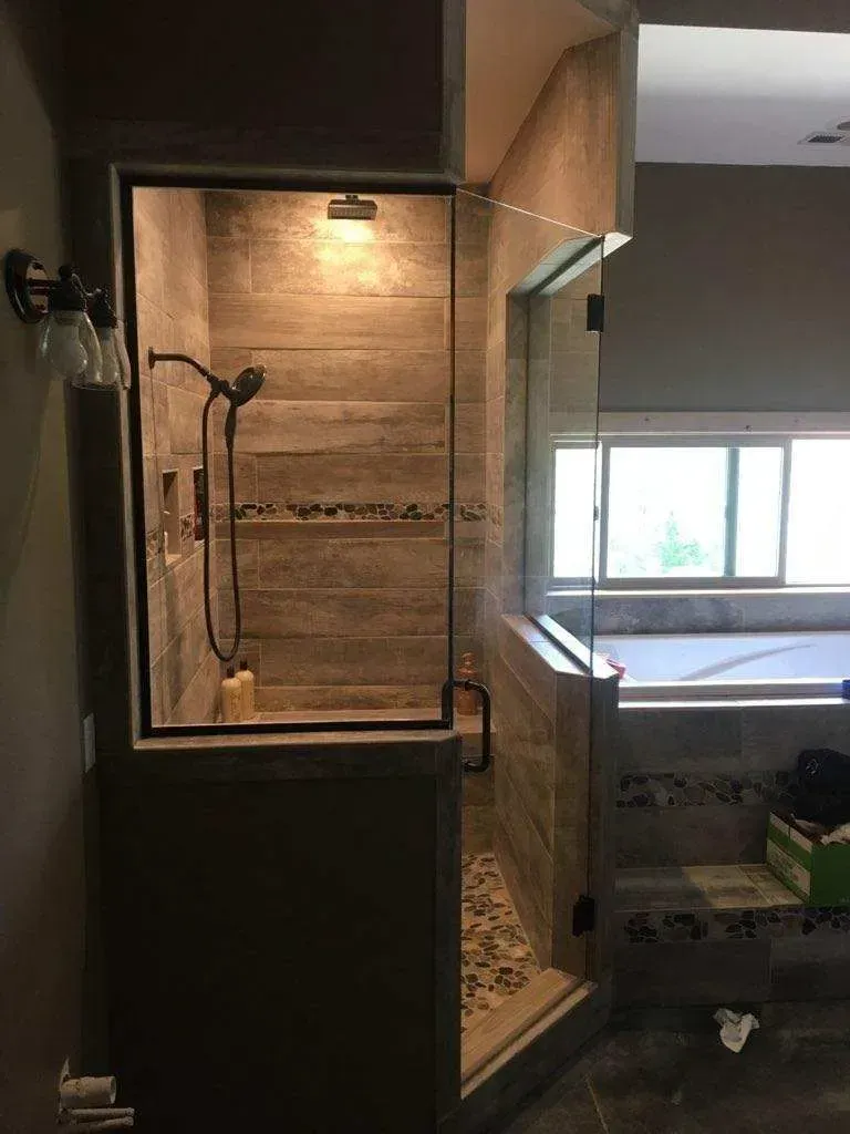 A bathroom with a walk in shower and a jacuzzi tub.