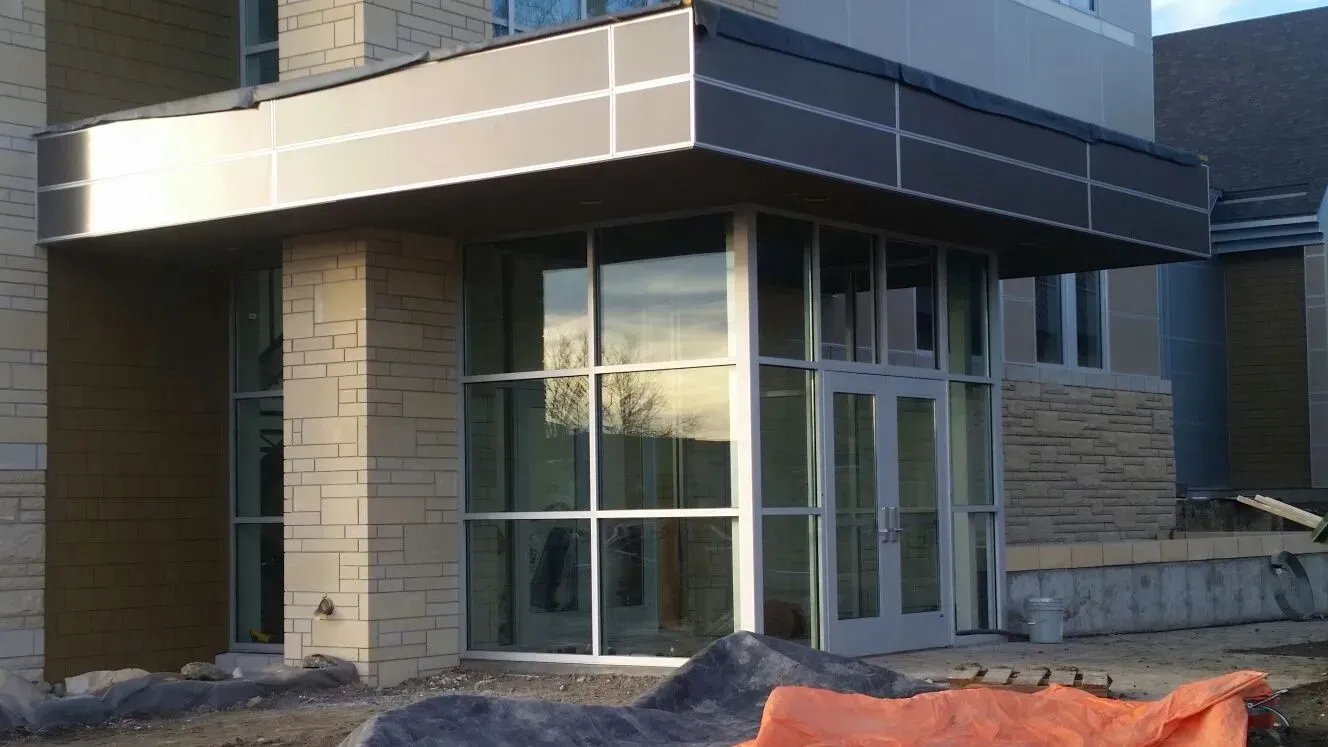 A large building with a lot of windows is under construction.