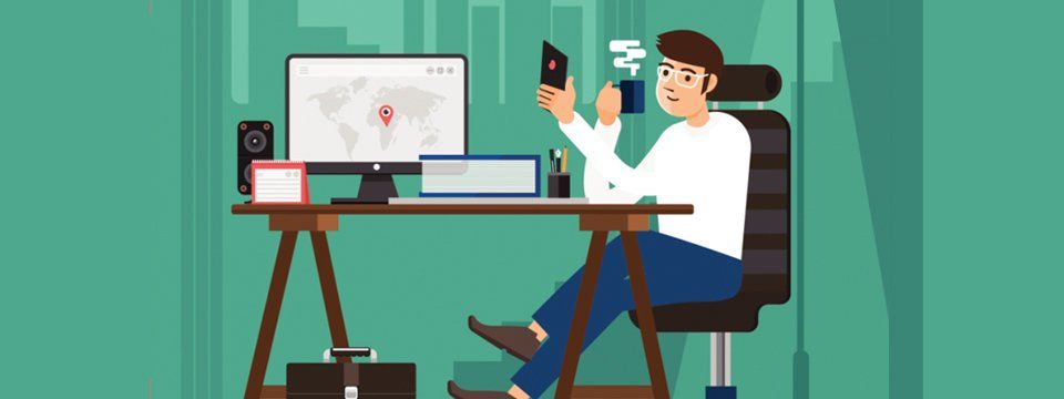 Cartoon of a bespectacled man sitting at an office desk holding a hot drink