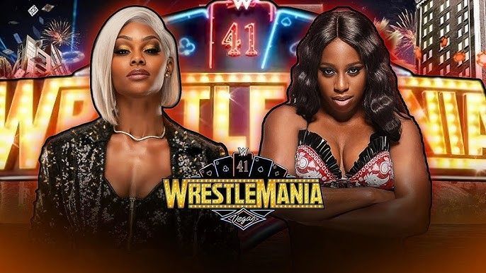 Two women are standing next to each other in front of a sign that says wrestlemania.