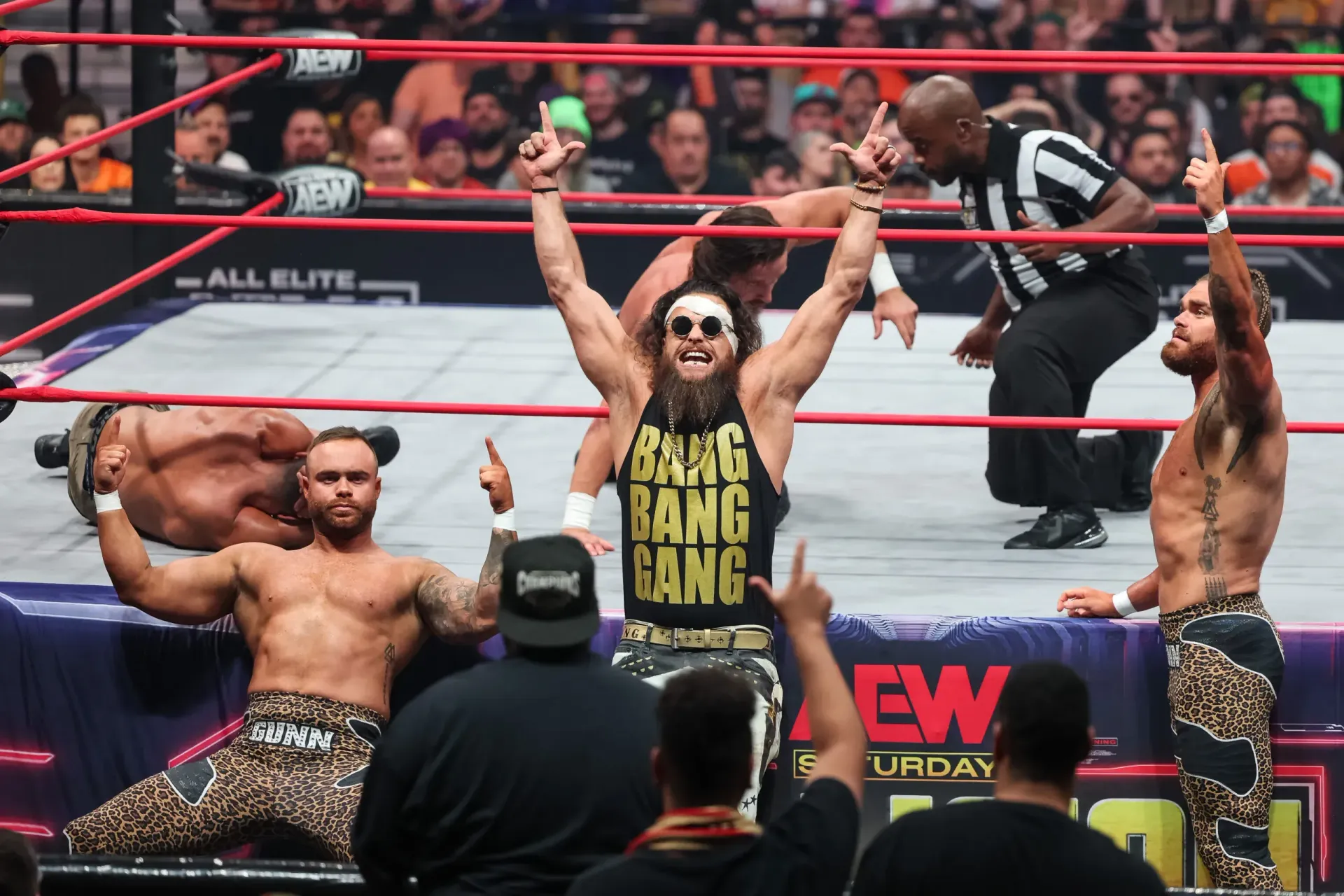 A wrestler wearing a shirt that says bang bang bang
