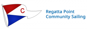A logo for regatta point community sailing with a red white and blue flag