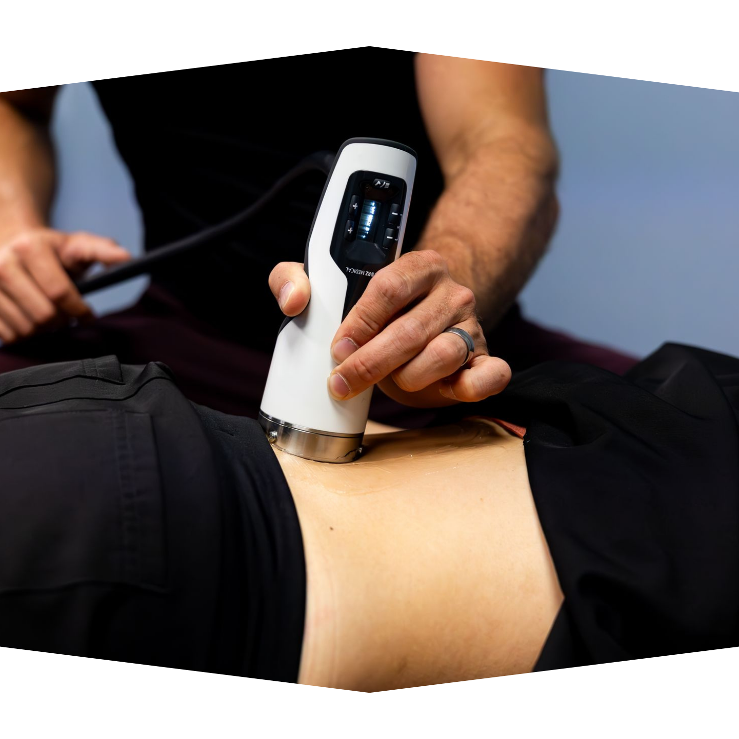 An older woman is sitting on the beach and smiling