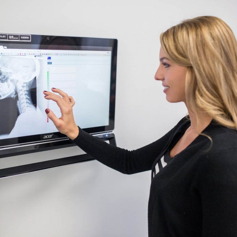 A woman is pointing at an acer computer monitor