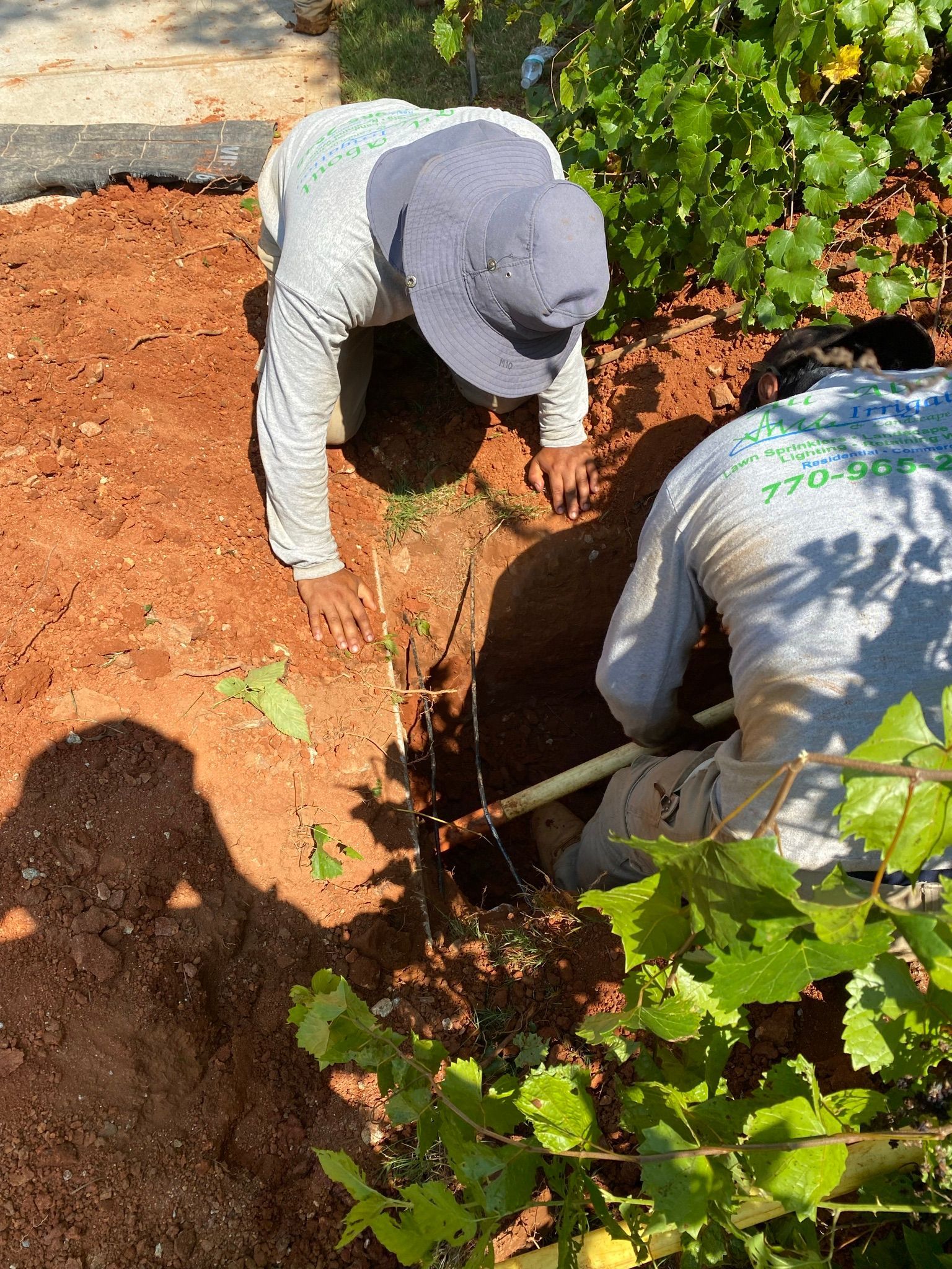 Two People Digging — Flowery Branch, GA — All About Irrigation and Landscape Services Inc