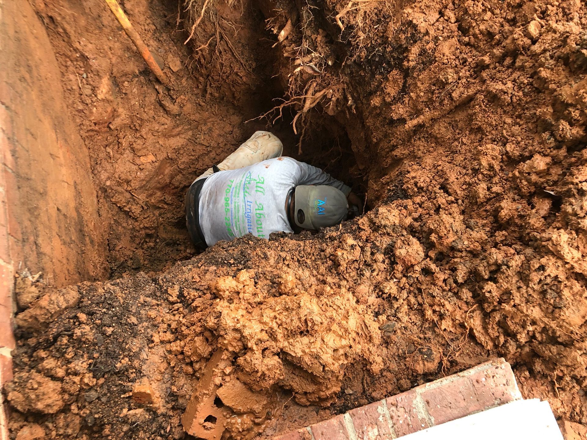 Man on a Pit — Flowery Branch, GA — All About Irrigation and Landscape Services Inc