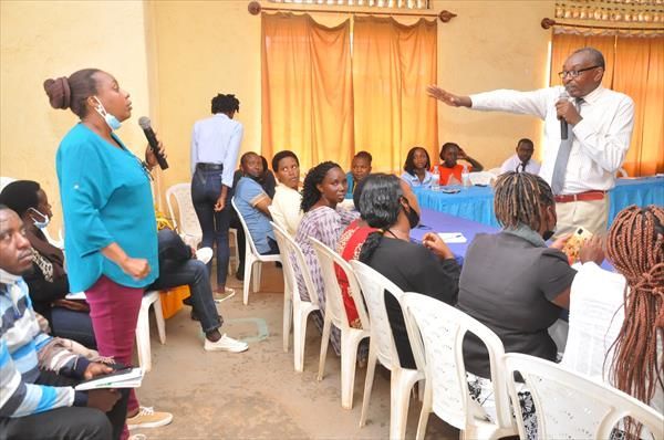 Man and Woman speaking at Reach Rwanda