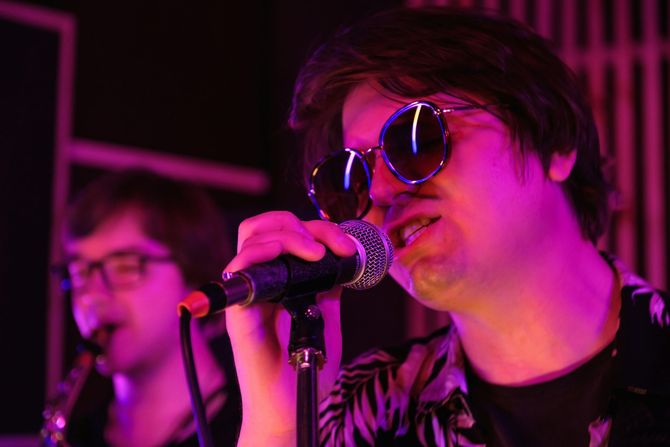 A blurry picture of a crowd of people dancing in a club.