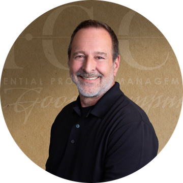 Man in black shirt smiling, against a golden background with text 