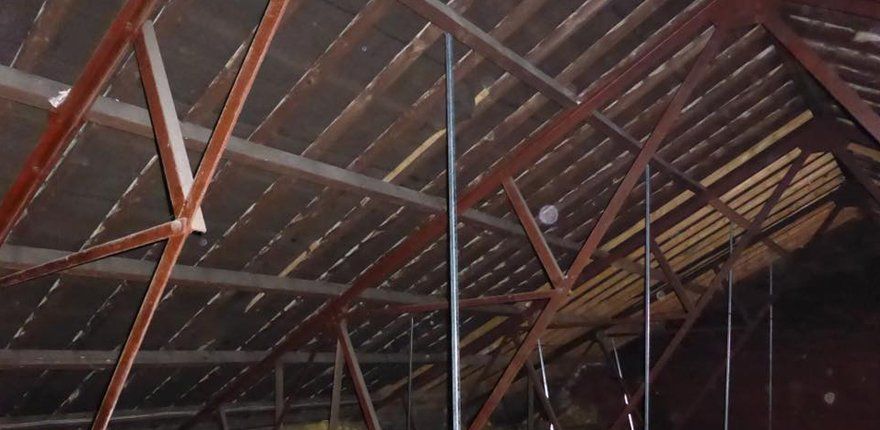 Steel roof structures in a large timber building