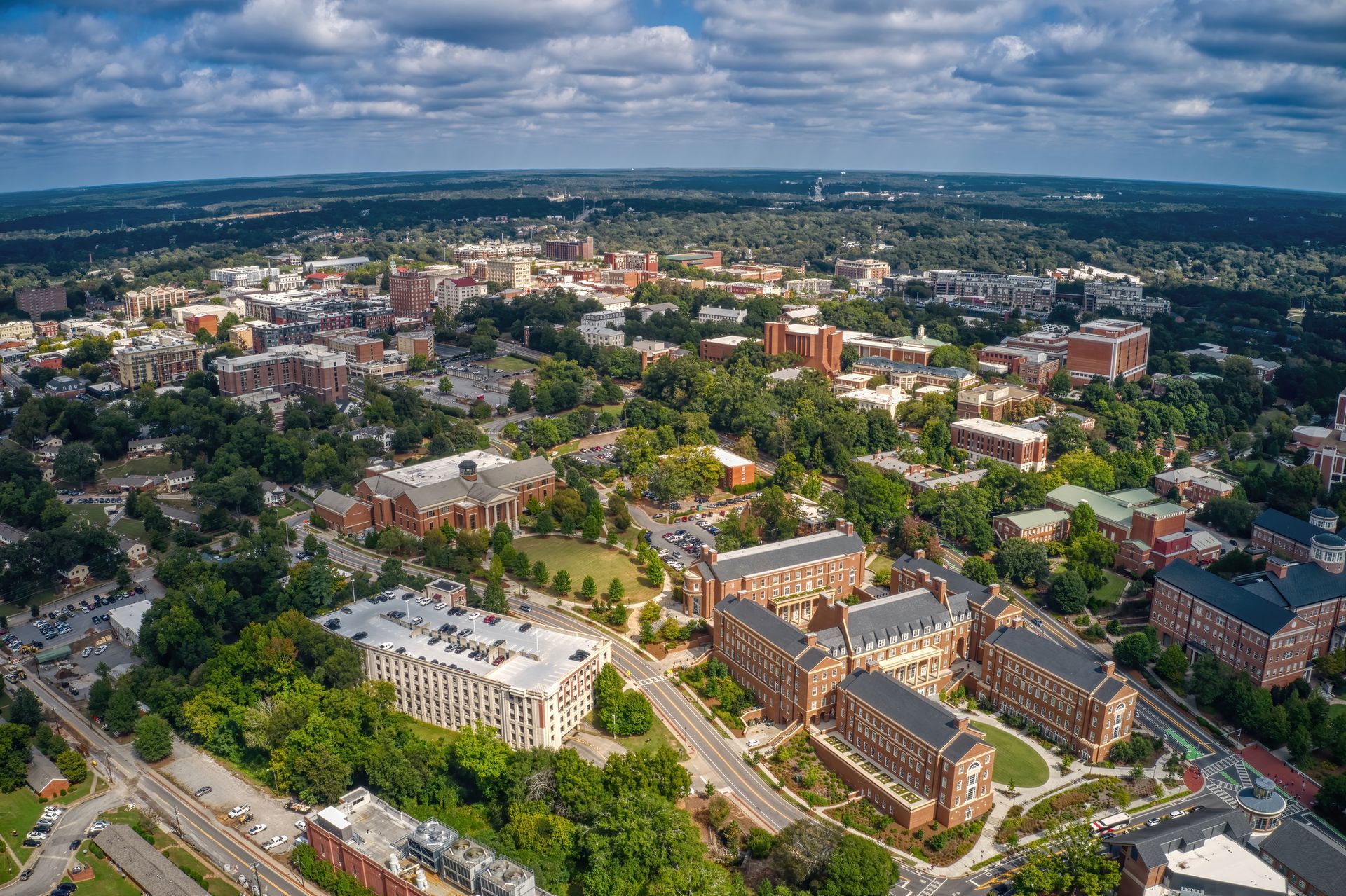 An aerial view of a city with lots of buildings and trees.