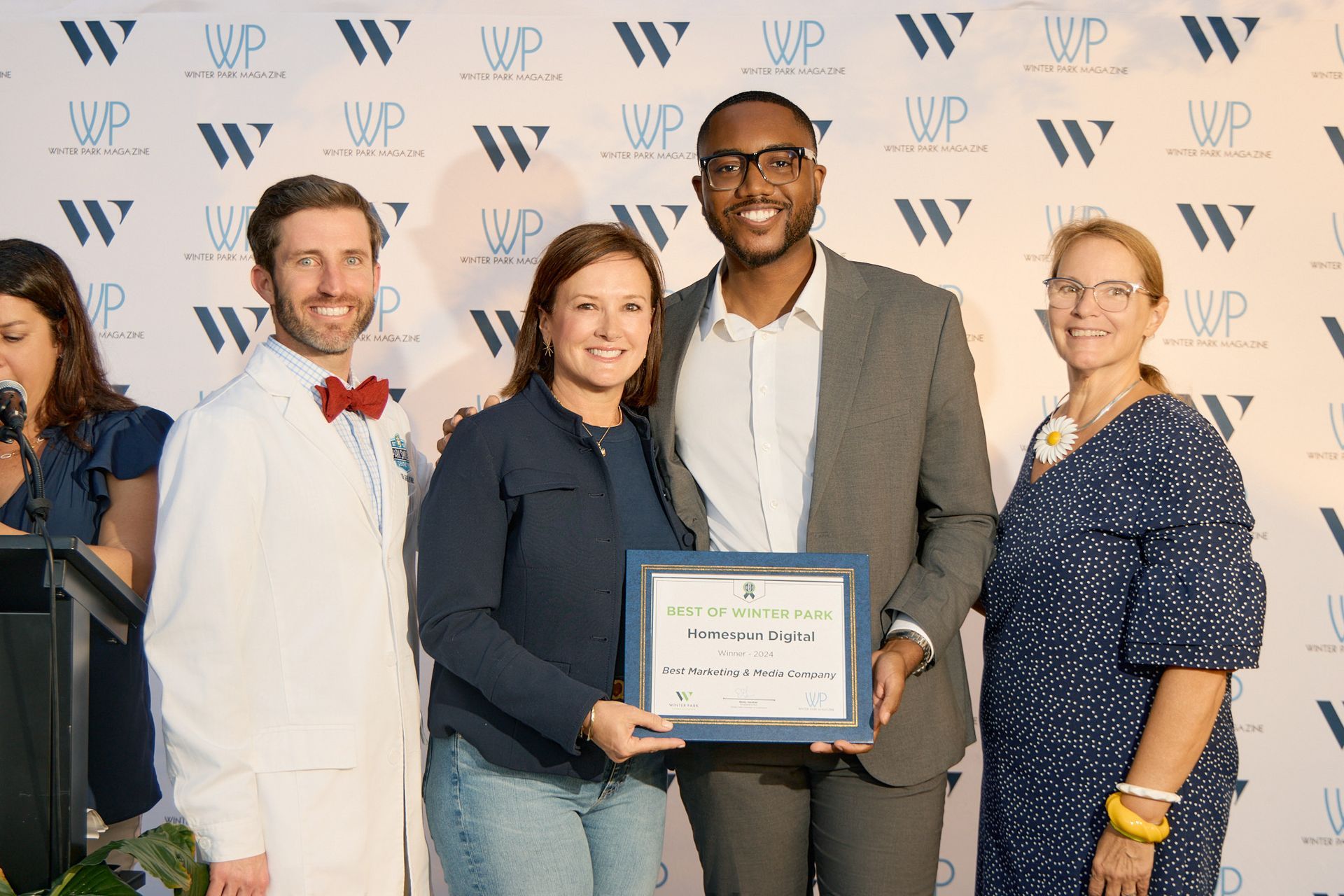 A group of people standing next to each other holding a certificate.