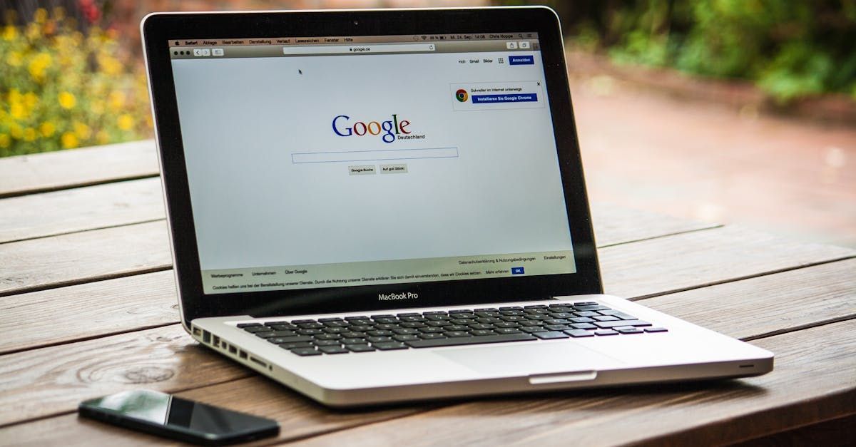 A laptop computer is open to a google page on a wooden table.