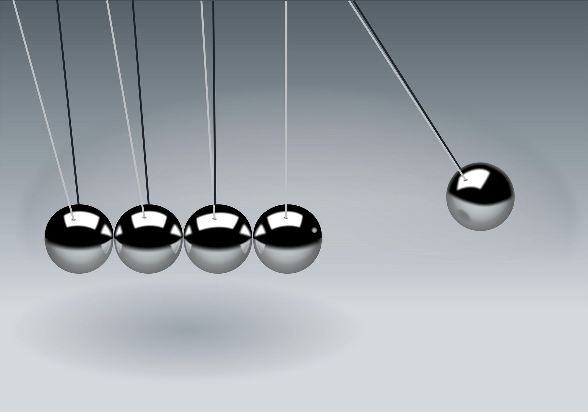 A newton 's cradle with five metal balls hanging from a string