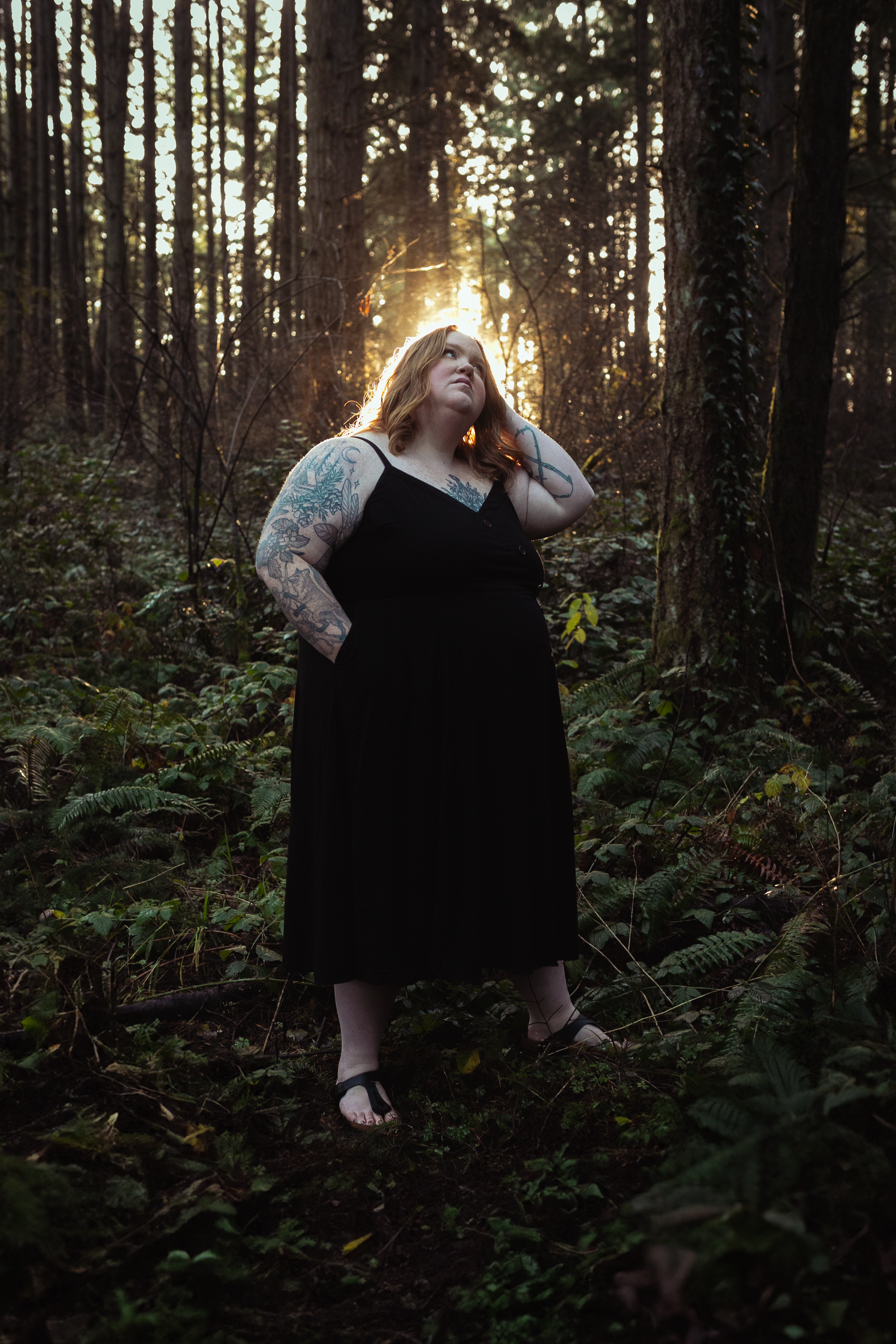 Woman in forest being backlit by sun